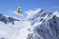 Skier jump in the mountains. Extreme ski sport. Freeride.