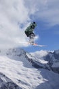 Skier jump in the mountains. Extreme ski sport. Freeride.