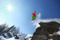 Skier jumping against blue sky from the rock Royalty Free Stock Photo