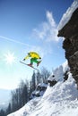 Skier jumping against blue sky from the rock Royalty Free Stock Photo