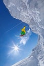 Skier jumping against blue sky from the rock Royalty Free Stock Photo