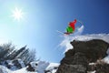 Skier jumping against blue sky from the rock