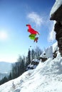 Skier jumping against blue sky from the rock