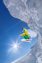 Skier jumping against blue sky from the rock Royalty Free Stock Photo