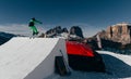 Skier jumping on kicker, balloon landing, Val di Fassa Dolomiti snow park