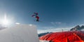 Skier jumping on kicker, balloon landing, Val di Fassa Dolomiti snow park