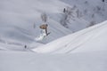 Skier jumps in the mountains. Mountain ski, winter extreme sport.