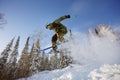 The skier jumps from a springboard in the ski resort.