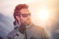 Skier man detail wearing anorak jacket with sunglasses portrait. exploring snowy land walking and skiing with alpine ski