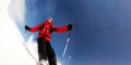 Skier in mountains performs a high speed turn on a ski piste Royalty Free Stock Photo