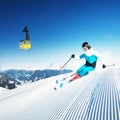 Skier in mountains, prepared piste and sunny day