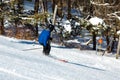 Skier performing slalom ride and having fun at resork in winter from the back Royalty Free Stock Photo