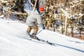 Skier performing slalom ride and having fun at resork in winter from the back Royalty Free Stock Photo