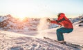 Skier playing with snow at sunset on ski mountain resort - Young athlete having fun on winter vacation - Sport and travel concept