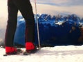Skier in red winter jacket with small fun skis stay in snow