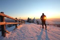 A skier is resting at a ski resort with beautiful view to the snowy mountains.