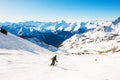 Skier rides down the slope in Alps mountains. Val Thorens, France