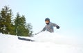 Skier skidding in the snow, off piste.