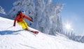 Skier skiing downhill in high mountains against blue sky Royalty Free Stock Photo