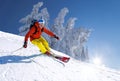 Skier skiing downhill in high mountains against blue sky Royalty Free Stock Photo