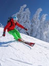 Skier skiing downhill in high mountains against blue sky Royalty Free Stock Photo