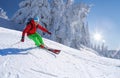 Skier skiing downhill in high mountains against blue sky Royalty Free Stock Photo