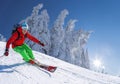 Skier skiing downhill in high mountains against blue sky Royalty Free Stock Photo