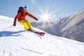 Alone Skier skiing downhill in high mountains against blue sky Royalty Free Stock Photo