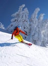 Skier skiing downhill in high mountains against blue sky Royalty Free Stock Photo