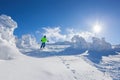Skier skiing downhill in high mountains against the fairytale winter forest Royalty Free Stock Photo