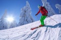 Skier skiing downhill in high mountains against sunset Royalty Free Stock Photo