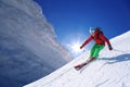 Skier skiing downhill in high mountains against sunset Royalty Free Stock Photo