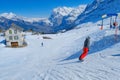 Skier skiing downhill in high mountains Kleine Scheidegg station at Switzerland