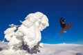 Skier skiing downhill jump during sunny day fresh snow freeride. Extreme High speed, frosty dust scatters Royalty Free Stock Photo