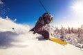 Skier skiing downhill during sunny day fresh snow freeride. Extreme High speed, frosty dust scatters