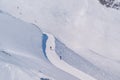 Skier skiing with helmet alone on the ski slope towards Matterhorn mountain on a beautiful sunny day in Switzerland Royalty Free Stock Photo