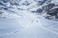 Skier skiing with helmet alone on the ski slope towards Matterhorn mountain on a beautiful sunny day in Switzerland Royalty Free Stock Photo