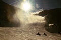 Skier in slope. A snowgun makes fresh powder snow. Snow making on slope. Mountain ski resort and winter calm. Royalty Free Stock Photo