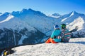 Skier and snowboarder at rest in long chairs