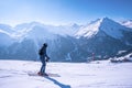 Skier in sportswear skiing on slope against mountain range Royalty Free Stock Photo