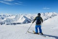 Skier standing in front of mountains Royalty Free Stock Photo