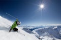 Skier with sun and mountains