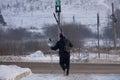 Skier walks down the slope with skis in his hands in the snow .