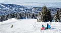 Skiers admiring the view of mountain in Kopaonik winter ski resort Serbia