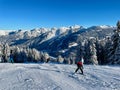 Skiers in the Austrian Alps on a sunny winter day, breathtaking panoramic view of snow-covered mountains. Royalty Free Stock Photo