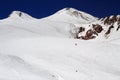 Skiers on the Azau glacier against the background of the peaks of Mount Elbrus Royalty Free Stock Photo