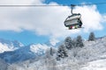 skiers in chairlift above beautiful snowy winter landscape in Alps