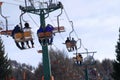 Skiers on the chairlift on the Italian Alps