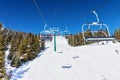 Skiers on Chairlift Up a Ski Slope in the Canadian Rockies Royalty Free Stock Photo