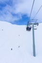 Skiers on Chairlift Up a Ski Slope in the Canadian Rockies Royalty Free Stock Photo